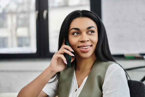 A vibrant woman connects on a phone call, brightening the office atmosphere. — Stock Photo