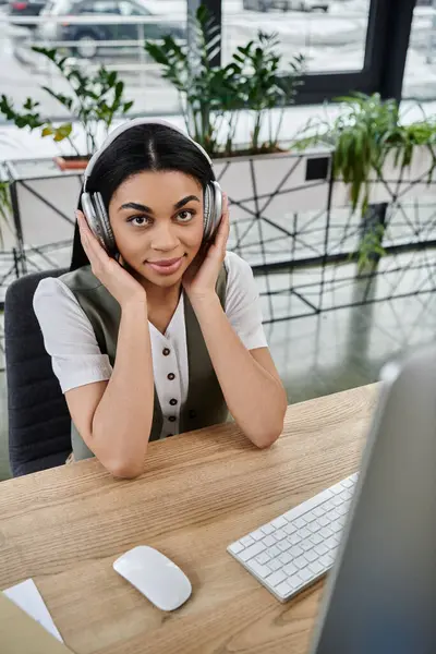 Woman with headphones immersed in music, relaxing in a contemporary office. — Stock Photo
