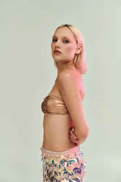 A fashion forward young woman displays her holographic themed outfit with elegance. — Stock Photo