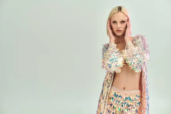 Stylish individual showcases a striking holographic outfit with confidence and poise. — Stock Photo