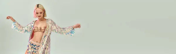 A young woman in stunning holographic fashion joyfully dances with flair. — Stock Photo