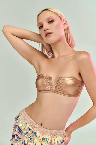 A young woman showcases fashionable attire with shimmering effects. — Stock Photo