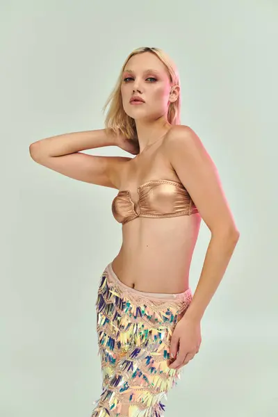 A fashionable young woman showcases her unique holographic outfit gracefully. — Stock Photo