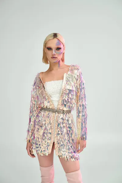 A radiant young woman showcases avant garde attire with shimmering details. — Stock Photo