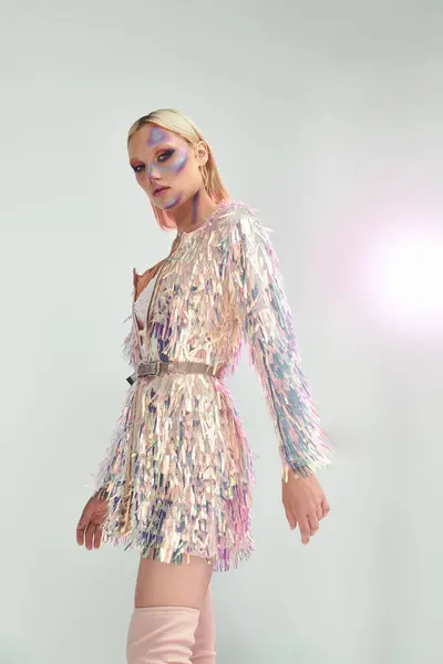 A stylish young woman exudes charm in a holographic ensemble with shimmering details. — Stock Photo