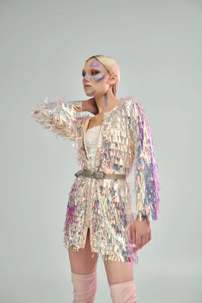 A young woman showcases her fashionable holographic outfit with confidence. — Stock Photo
