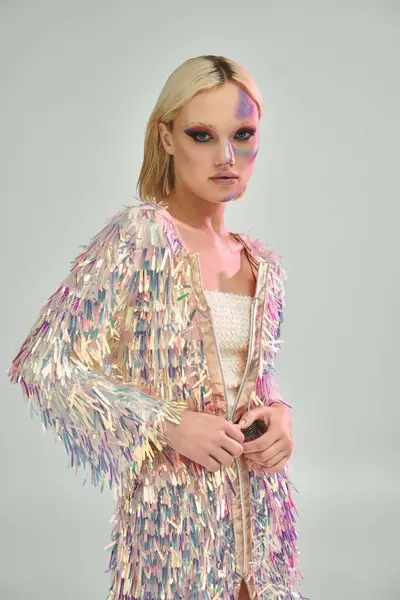 A young woman showcases a shimmering outfit with holographic elements. — Stock Photo
