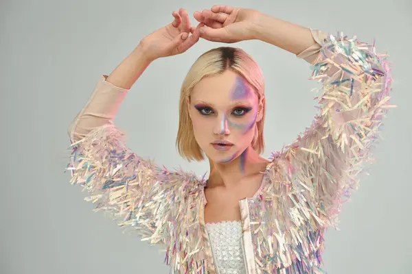A young woman showcases her fashion forward attire with shimmering holographic accents. — Stock Photo