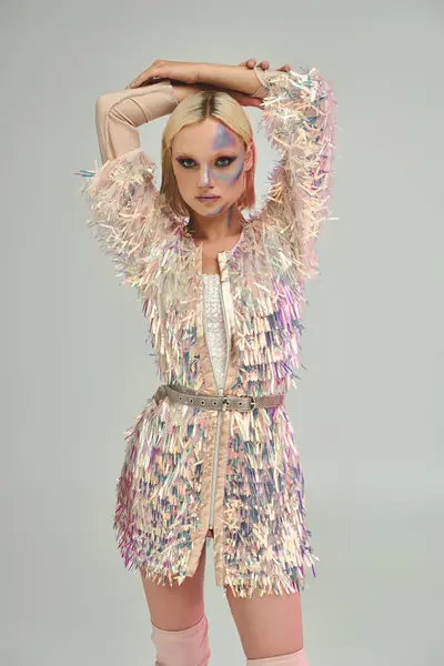 A fashionable young woman showcases her unique holographic outfit with striking confidence. — Stock Photo