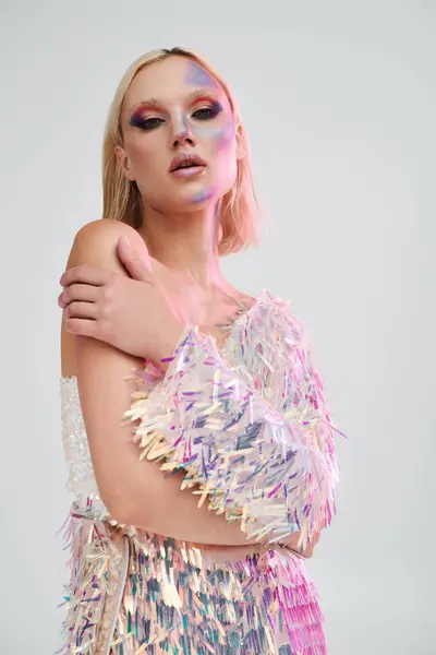A stylish young woman showcases her unique holographic attire in a creative studio. — Stock Photo
