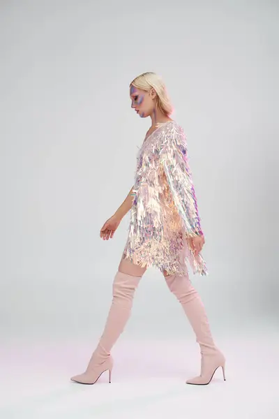 A stylish woman walks confidently, showcasing shimmering holographic fashion. — Stock Photo