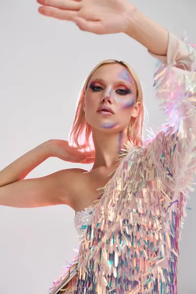 A young woman flaunts vibrant holographic attire with an expressive pose. — Stock Photo