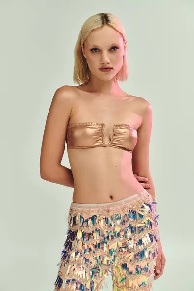 A young woman showcases her chic holographic outfit beautifully. — Stock Photo