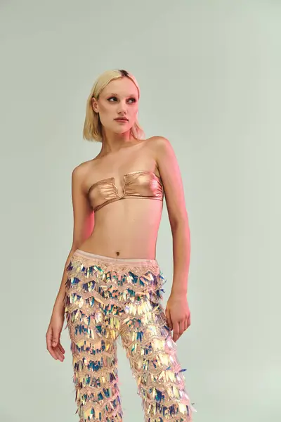 A confident woman showcases her shimmering outfit with vibrant holographic elements. — Stock Photo