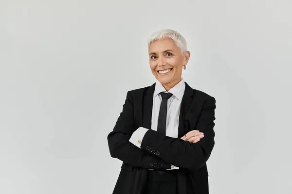 Mature woman exudes confidence with stylish attire and a warm smile. — Stock Photo