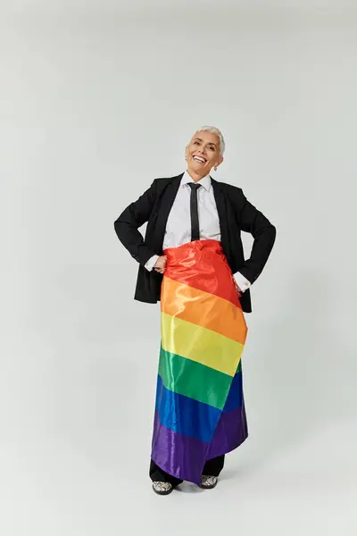 A stylish woman joyfully embraces her identity with vibrant rainbow pride. — Stock Photo