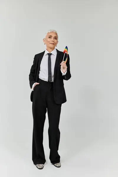 A proud woman holds a rainbow flag, showcasing her unique style and confidence. — Stock Photo