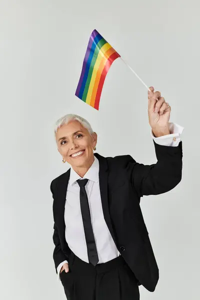 Confidently waving a rainbow flag, a stylish woman embraces pride and joy. — Stock Photo