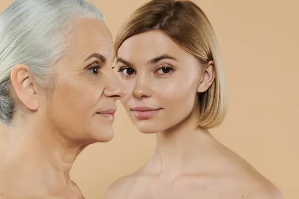A mature woman shares a tender moment with her adult daughter. — Stock Photo