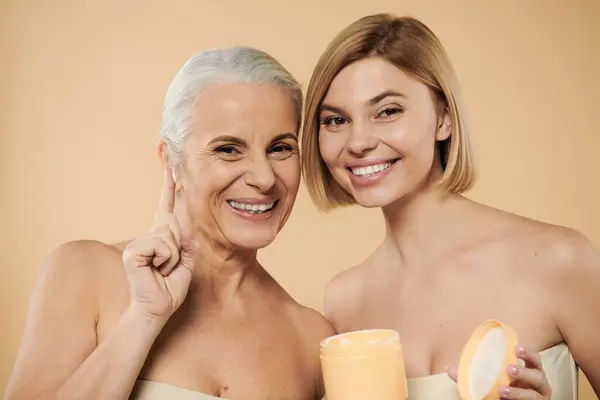 Two women share smiles while promoting beauty and self care. — Stock Photo