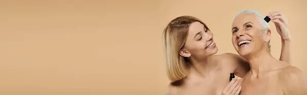 A mature woman and her daughter share a joyful beauty ritual together. — Stock Photo