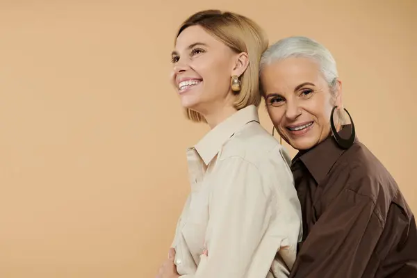 A mature woman and her adult daughter share a joyful moment together. — Stock Photo