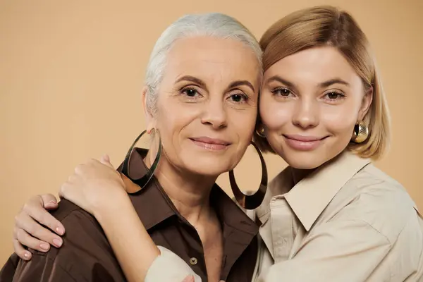 A lovely moment shared between a mature woman and her adult daughter. — Stock Photo