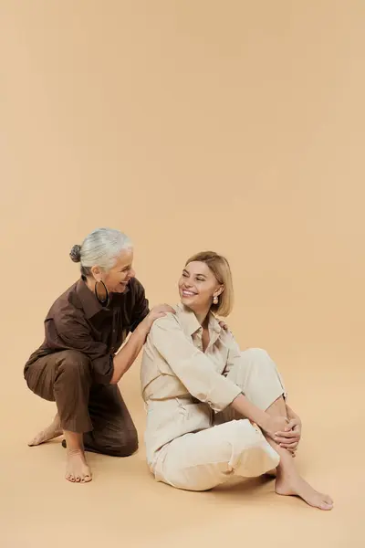 A mature woman shares a heartfelt laugh with her adult daughter. — Stock Photo