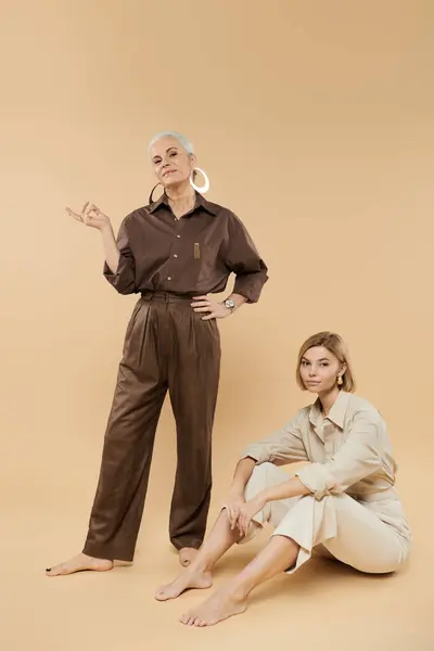 A stylish mature woman and her adult daughter exude confidence in their outfits. — Stock Photo