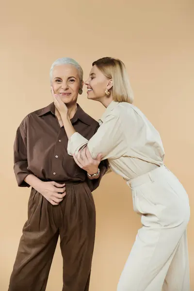 A mature woman and her daughter share a playful moment and smiles together. — Stock Photo