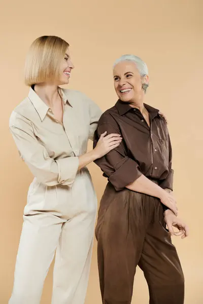 Two women share a warm smile and laughter, showcasing their strong connection. — Stock Photo