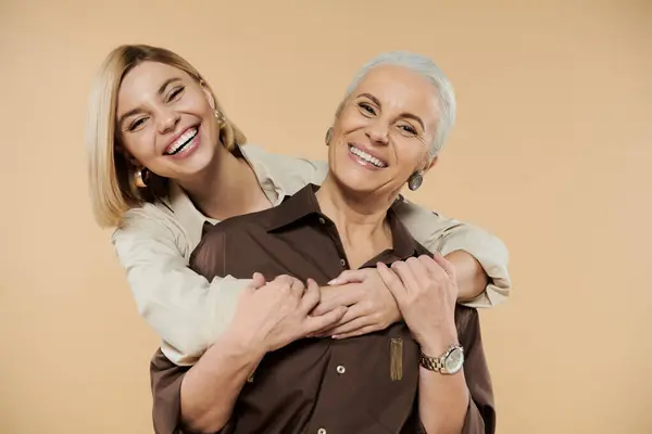 A mother and daughter share laughter and affection in a cozy environment. — Stock Photo
