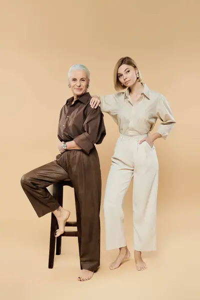 A mother and daughter show their fashion sense and connection while posing together. — Stock Photo