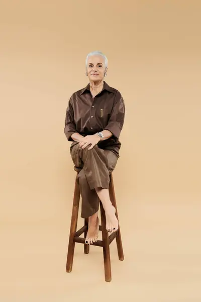 Uma mulher madura sentada e olhando para a câmera. — Fotografia de Stock