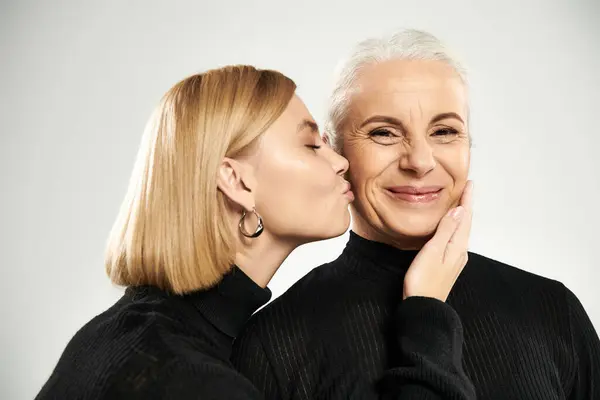 A loving moment shared between a mature woman and her daughter. — Stock Photo