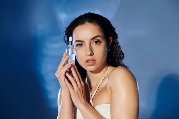 A young woman demonstrates her skincare regimen with elegance and confidence. — Stock Photo