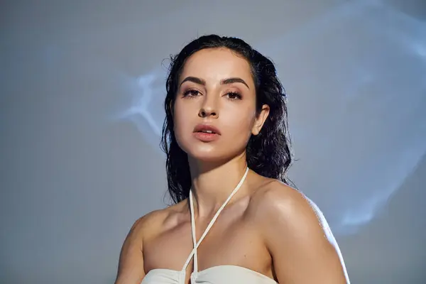 A beautiful young woman demonstrates her skincare routine with confidence. — Stock Photo