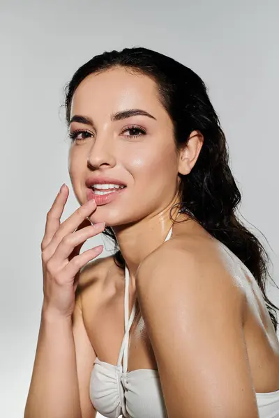 A young woman highlights her skincare routine with a radiant smile. — Stock Photo