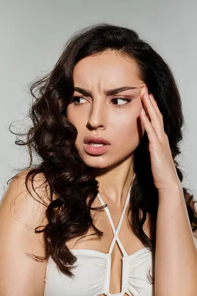 Graceful woman poses confidently on white backdrop. — Stock Photo