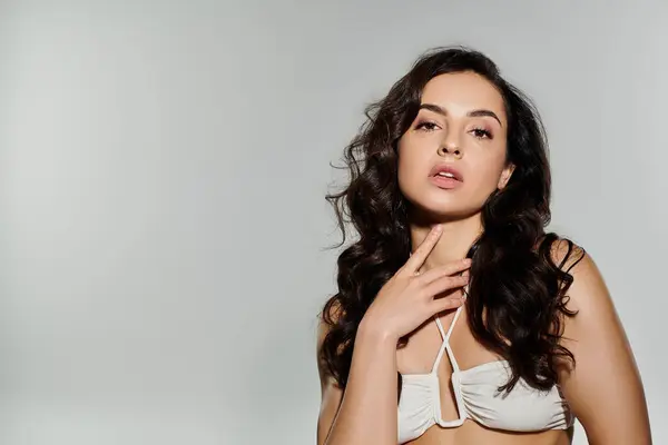 Pretty woman with long hair posing on white backdrop. — Stock Photo