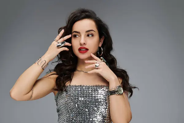 A stylish young woman showcases her elegance with dazzling jewelry in a vibrant setting. — Stock Photo