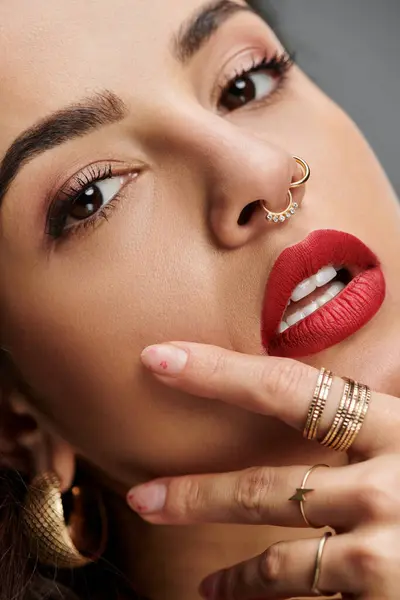 A captivating young woman showcases her beauty and jewelry in rich colors. — Stock Photo