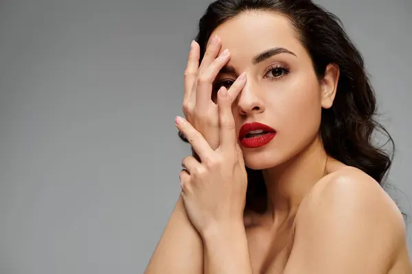 Una joven mujer muestra elegantemente su belleza con colores vibrantes a su alrededor. - foto de stock