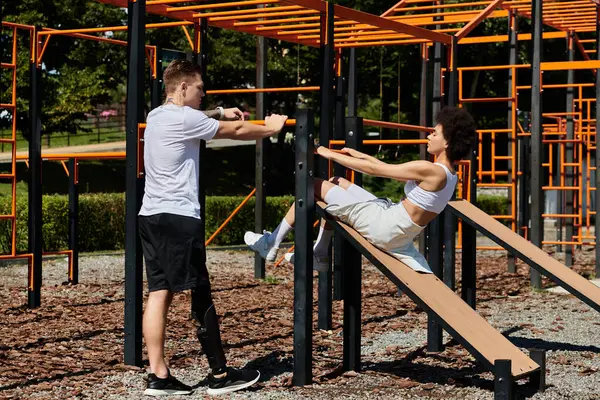 Two friends engage in an outdoor workout, showcasing strength and camaraderie amidst nature, man with prosthetic leg — Stock Photo