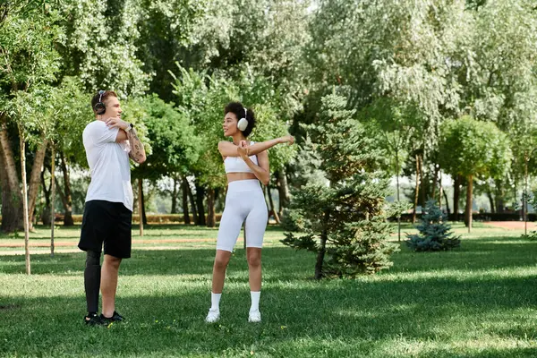 Two friends warm up outside, celebrating fitness, diversity, and camaraderie in a vibrant outdoor setting. — Stock Photo