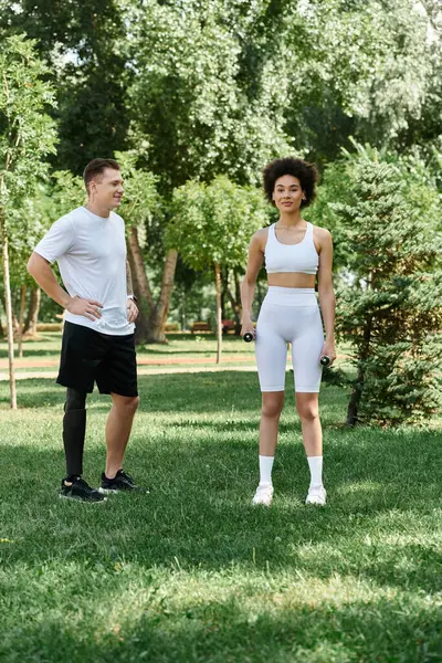 Two friends exercise in the park, showcasing strength and friendship while promoting inclusivity. — Stock Photo