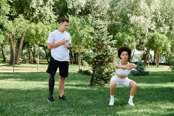 Two friends are exercising outdoors, showcasing friendship and determination in a lush green park. — Stock Photo