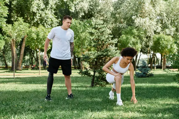 Two friends engage in an energetic outdoor workout, showcasing strength and camaraderie. — Stock Photo