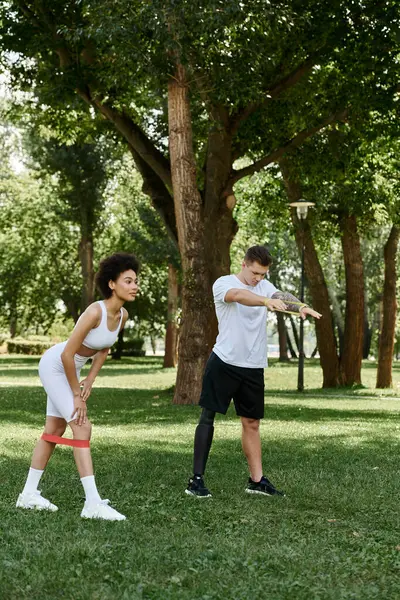 Two friends workout together in a vibrant outdoor setting, showcasing strength and resilience. — Stock Photo