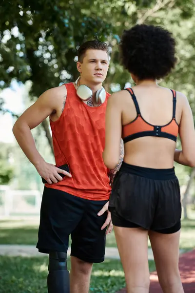 A young woman and her friend motivate each other during an energetic outdoor workout. — Stock Photo